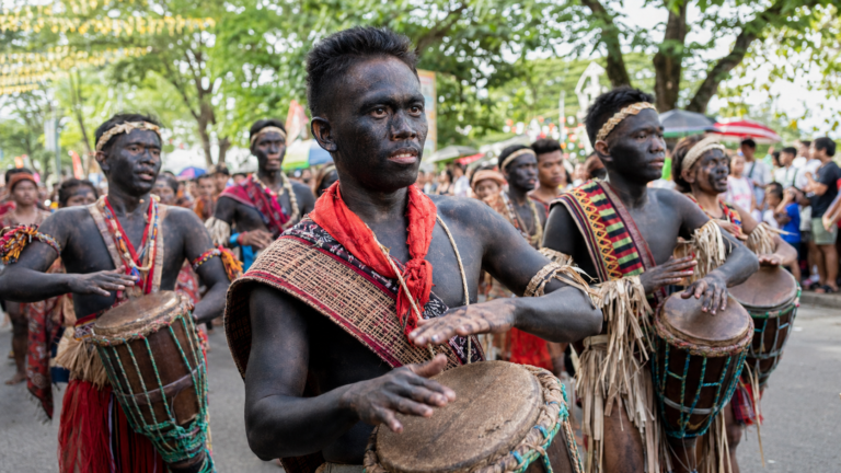 Ati-Atihan festival participants playing drums in Kalibo, Aklan
