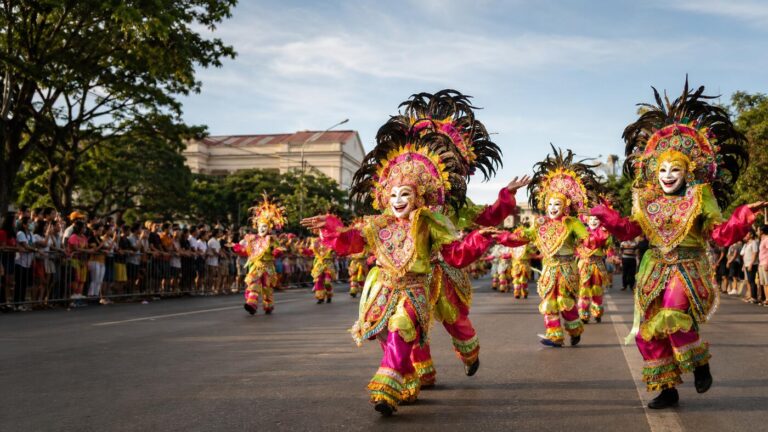 MassKara Festival dancers wearing smiling masks during a Bacolod street parade