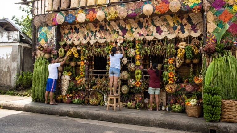Residents arranging kiping, produce and handicraft decorations for Pahiyas Festival in Lucban