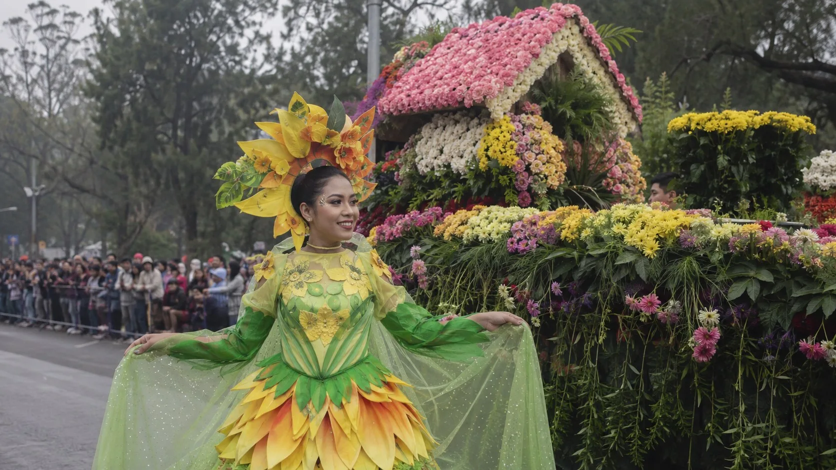 Panagbenga Festival performer beside a floral float in Baguio City
