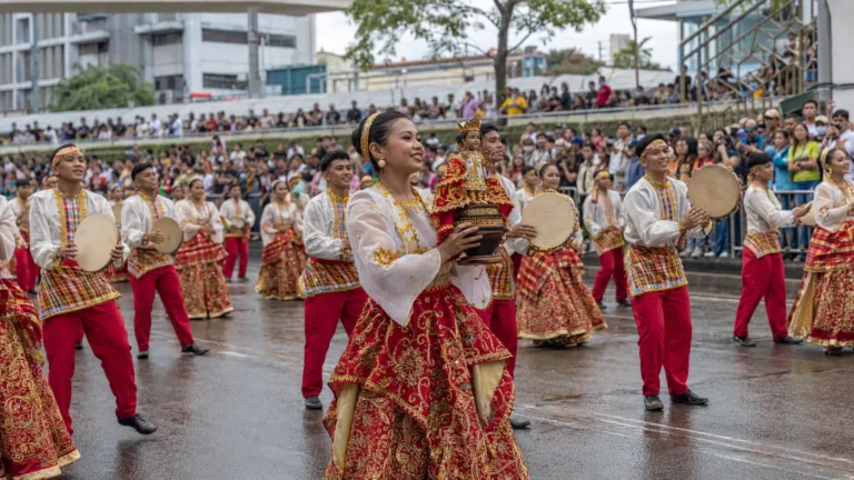 Sinulog cultural dancers carrying the Santo Niño during a Cebu City street performance